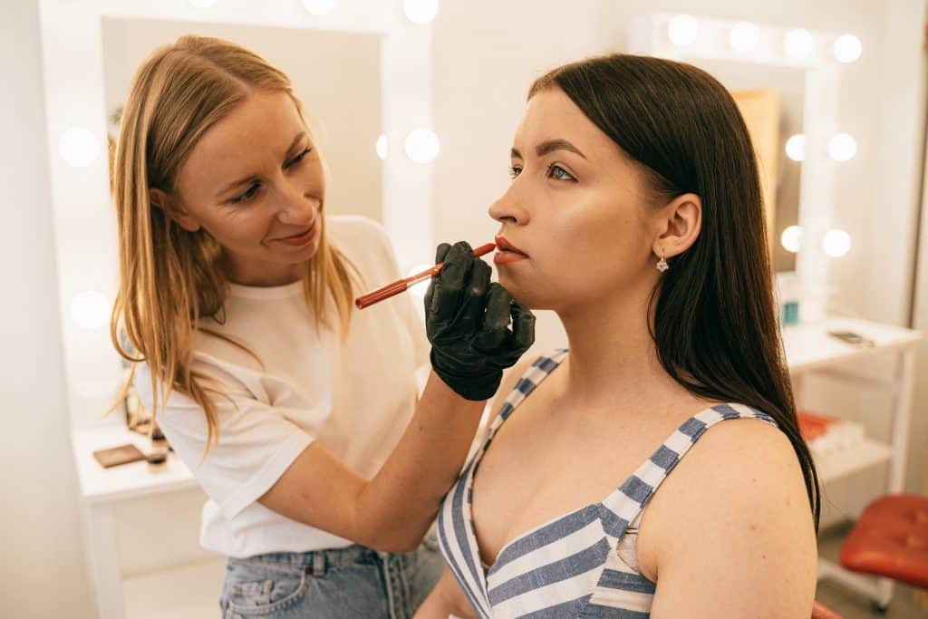 A woman receiving professional makeup application