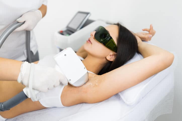 Client receiving laser hair removal from a certified medical aesthetician